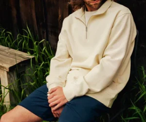 Man sitting wearing zipper crew shirt