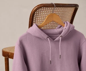 Purple hoodie hanging on chair